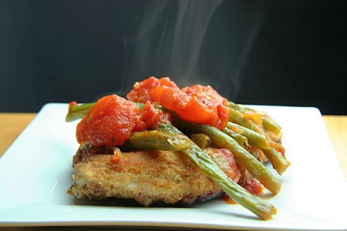 Breaded, fried pork chops with the popular green bean and stewed tomatoes recipe.